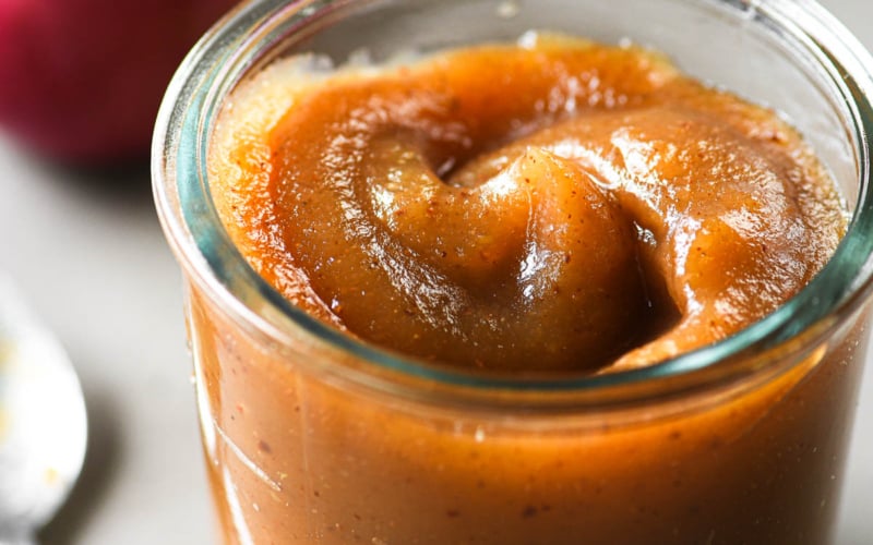 apple butter in a jar with spoon