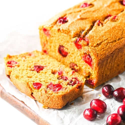 cranberry pumpkin cornbread on a bread board.