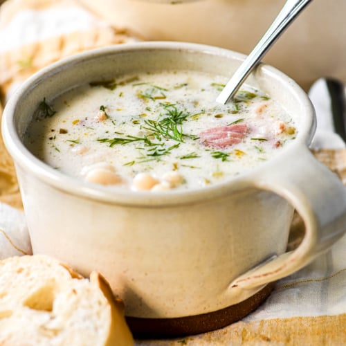 Romanian Bacon Soup in a white stoneware mug.