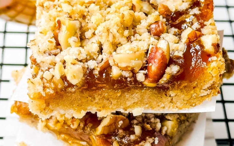 pumpkin butter bars stacked on a cooling rack.