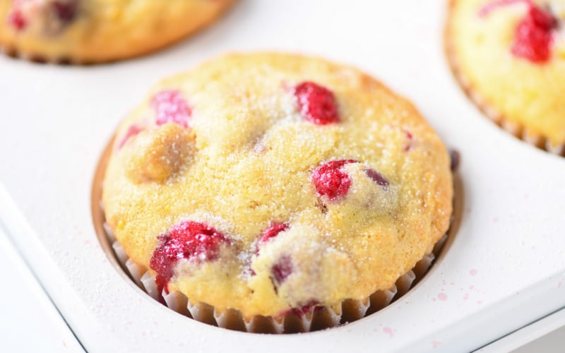 cranberry orange muffins in muffin pan.