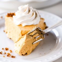 Slice of pumpkin chiffon pie with whipped cream.