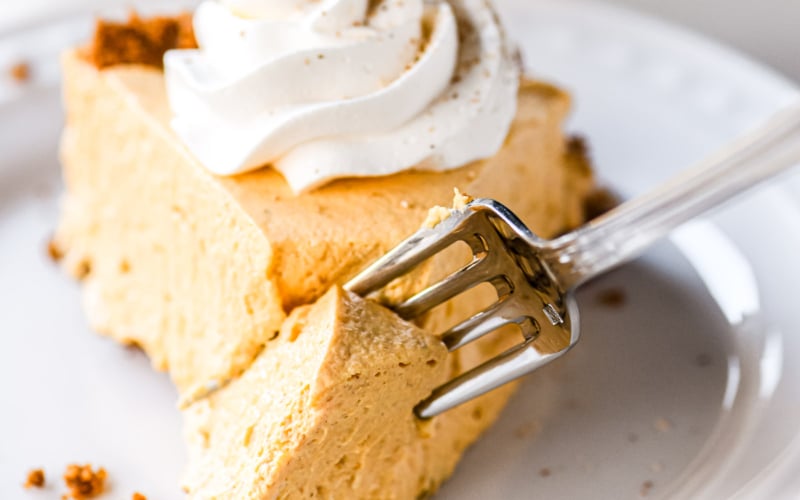 Slice of pumpkin chiffon pie with whipped cream.