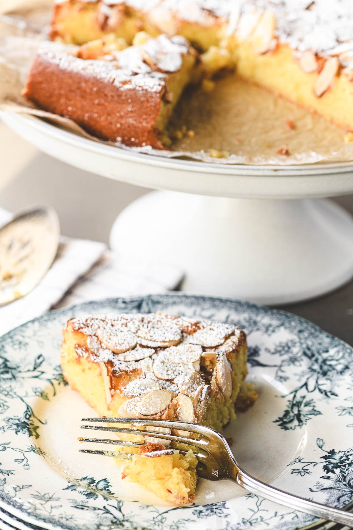 A piece of almond ricotta cake on plate.