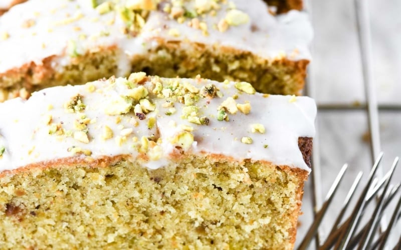 Cardamom pistachio pound cake, sliced with forks.