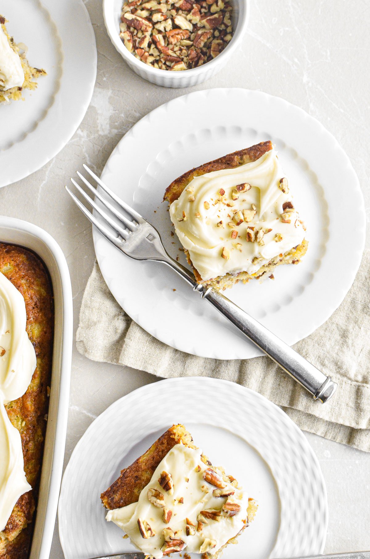 hummingbird cake bars on small white plates.