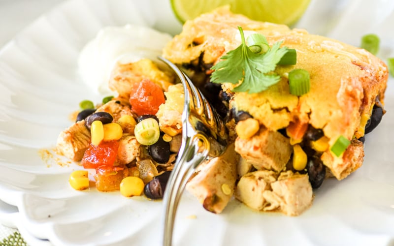A serving of Mexican Cornbread Casserole, loaded with chicken, cheese, and veggies.