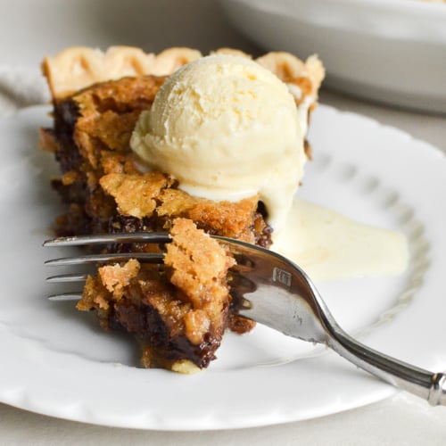 a slice of oatmeal chocolate chip cookie pie with ice cream.