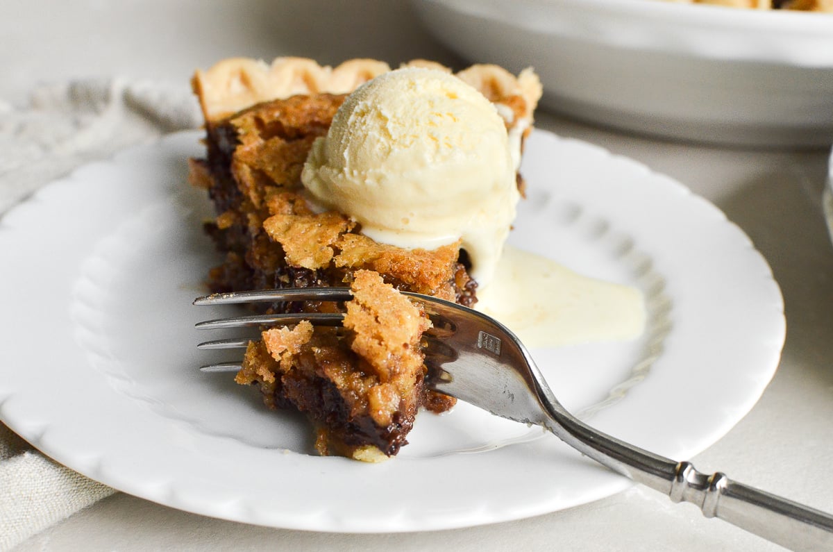 a slice of oatmeal chocolate chip cookie pie with ice cream.
