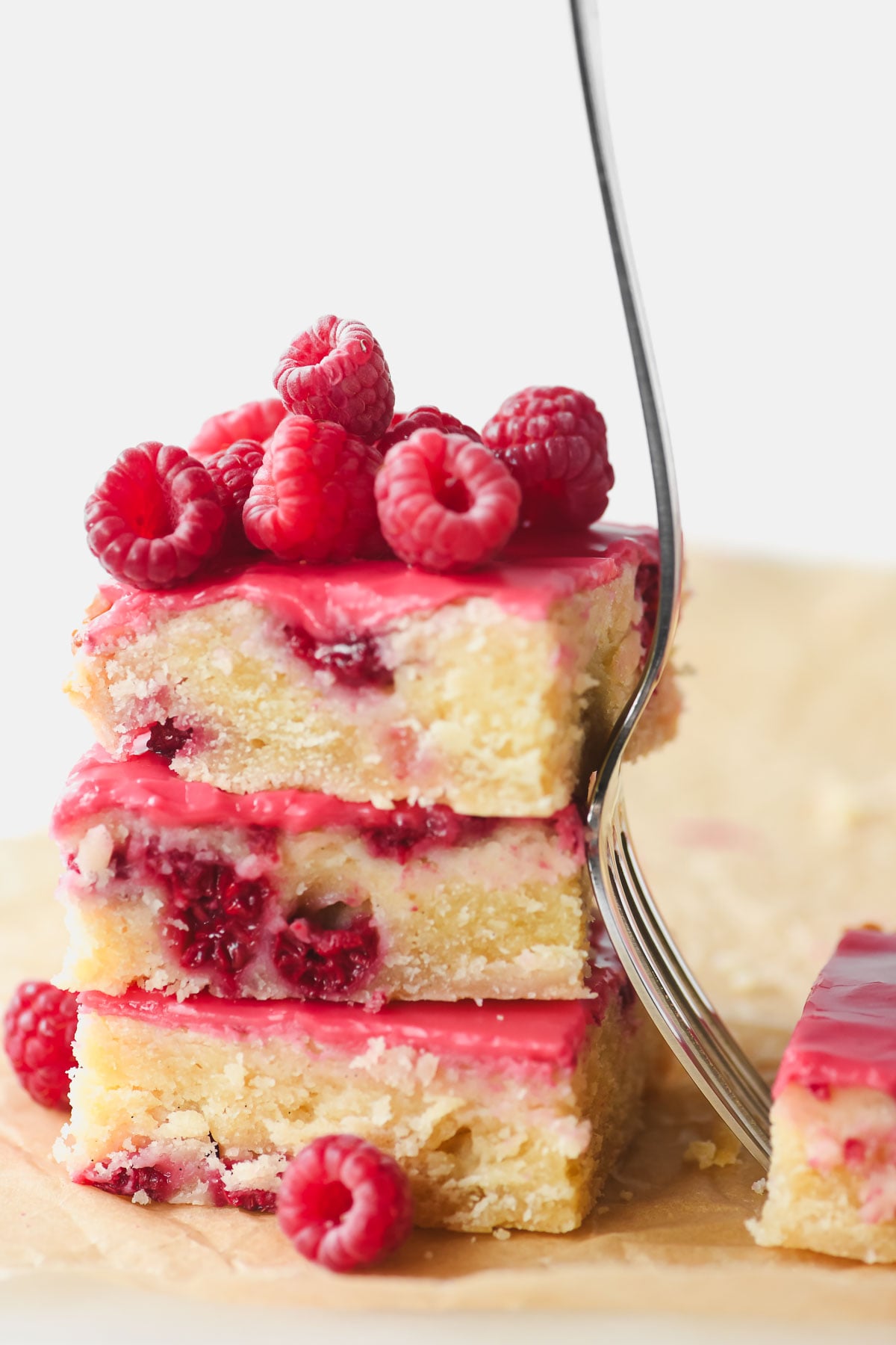 Raspberry lemon blondies stacked, with fork.