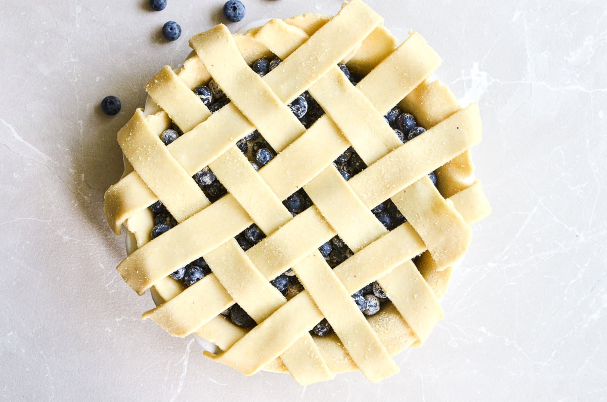 lattice pie crust on a blueberry pie.