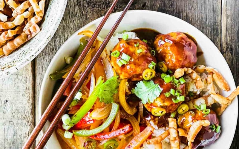 Firecracker chicken meatball bowl with fried wonton strips.