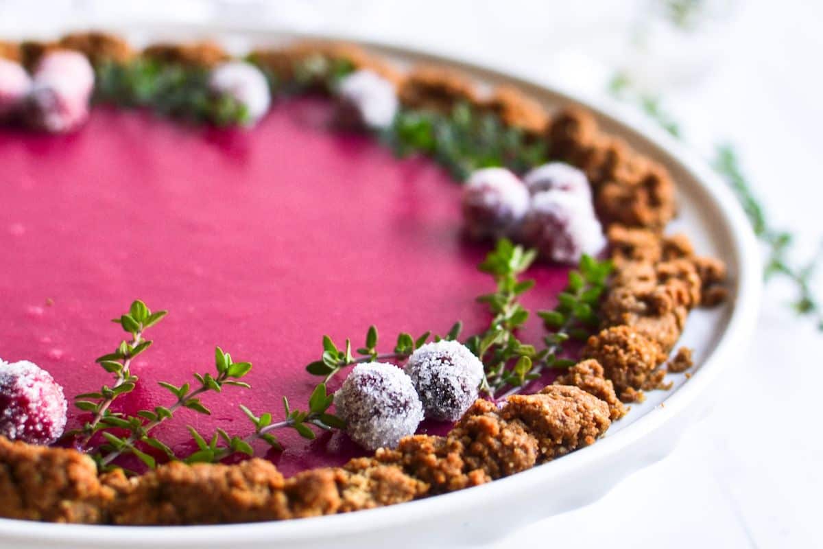 cranberry pie topped with sugared cranberries.
