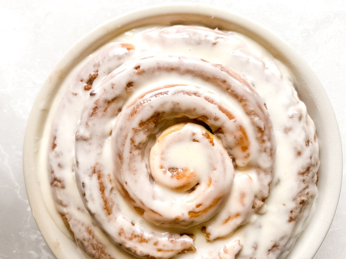 Giant cinnamon roll cake baked up in a pie plate.