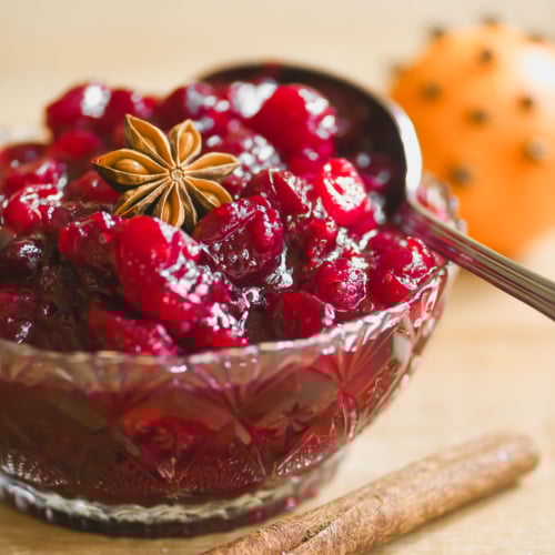 mulled wine cranberry sauce in a vintage glass bowl with cinnamon stick and star anise.