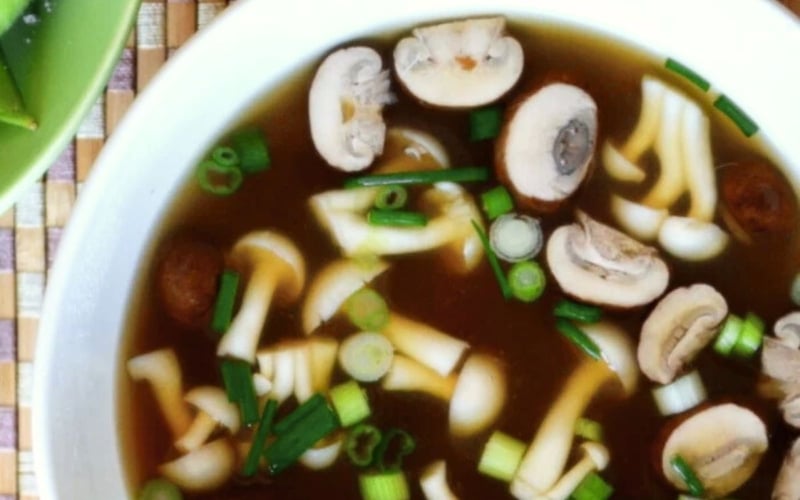 Miso soup in a white bowl.