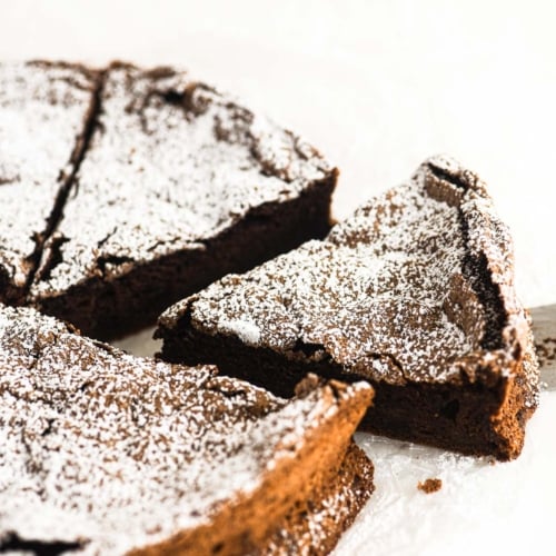 taking a slice of chocolate meringue cake.