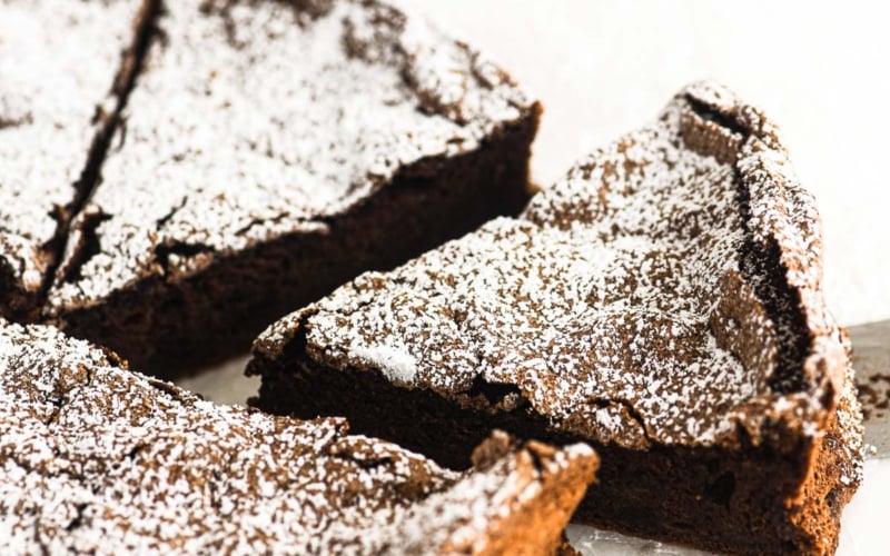 taking a slice of chocolate meringue cake.