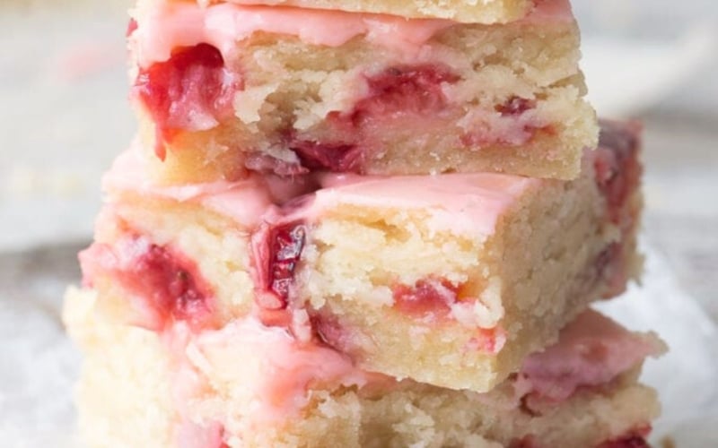 a stack of strawberry lemon blondies with forks.