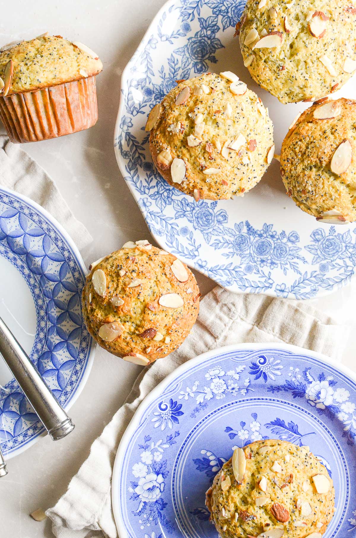 Almond poppy seed muffins on blue plates.
