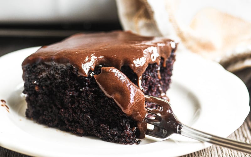A piece of hot fudge cake on a plate.