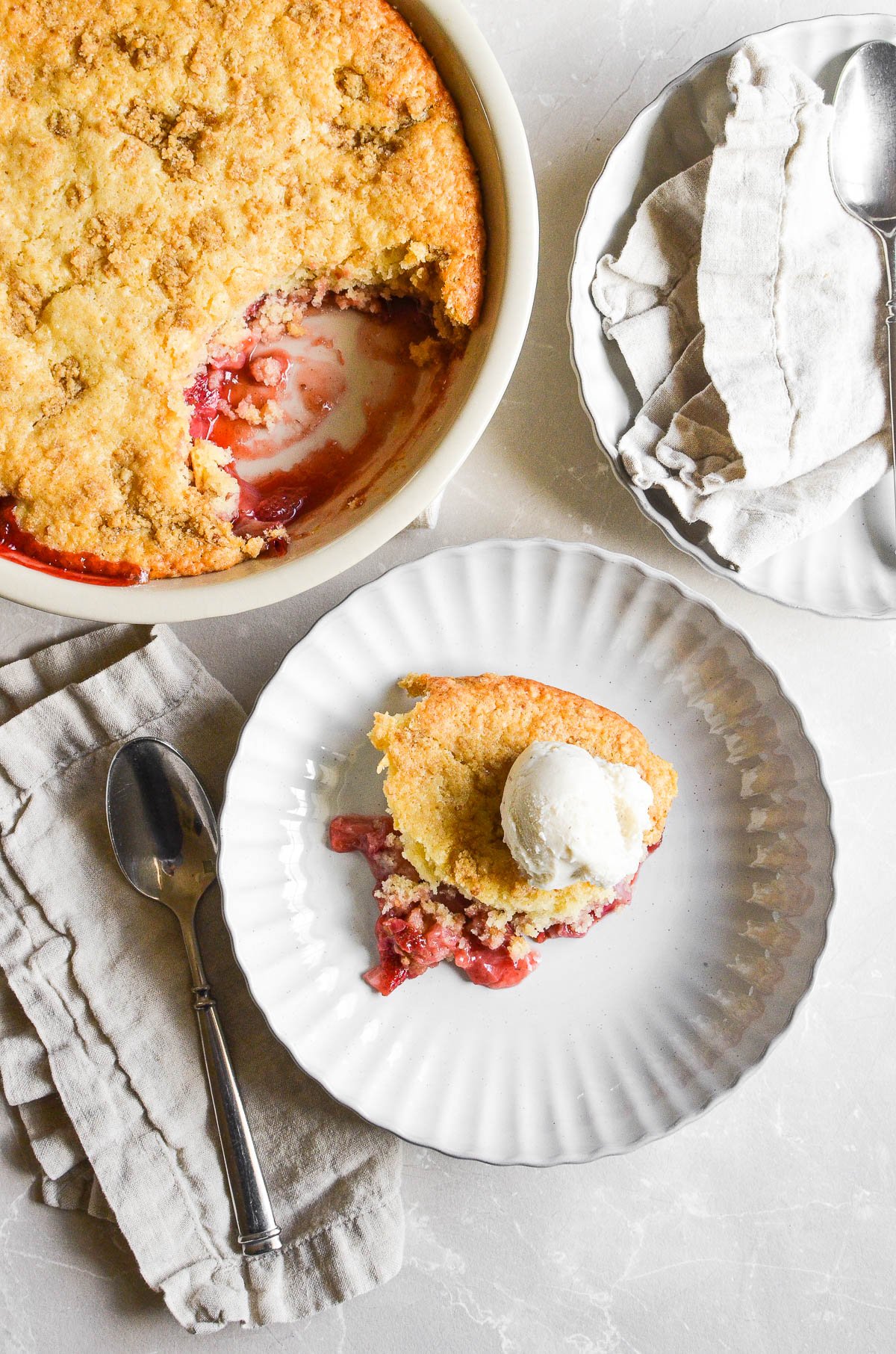A serving of strawberry cobbler in a white bowl.