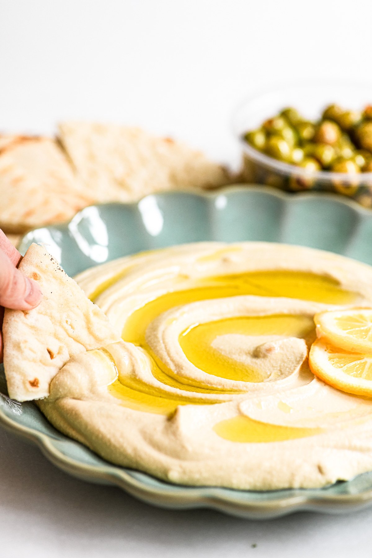 Meyer lemon hummus in a blue bowl.