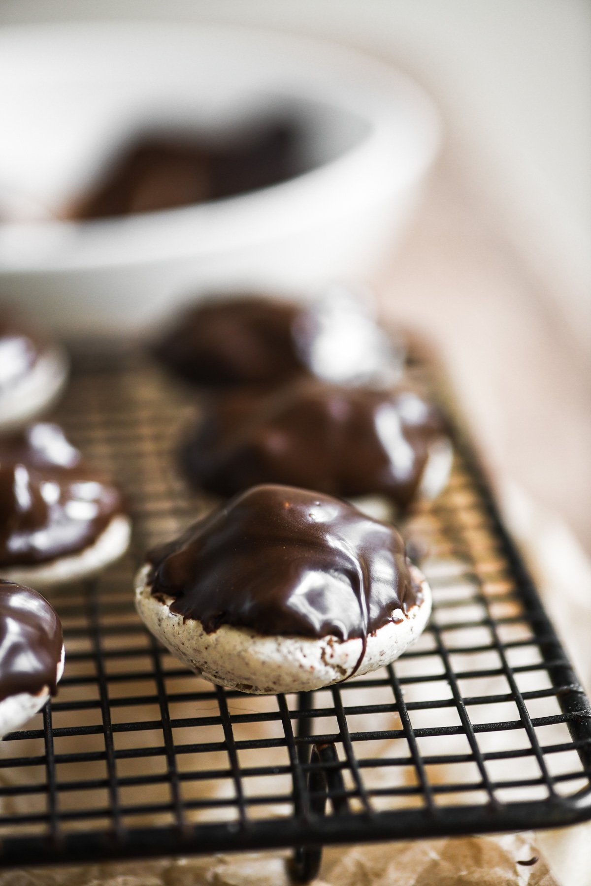sarah bernhardt cookies on a rack, topped with melted chocolate.
