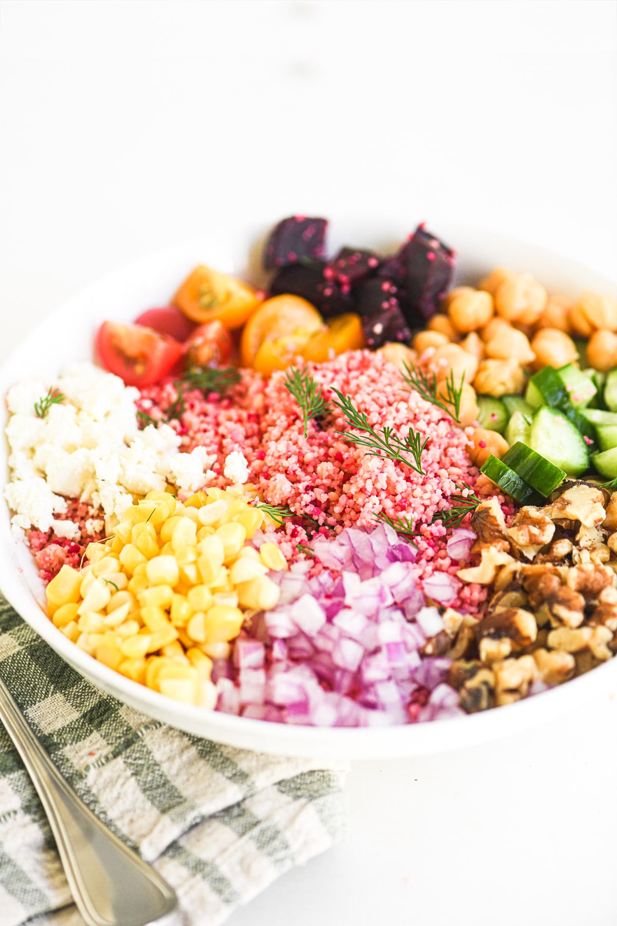 Summer couscous salad in a white bowl.