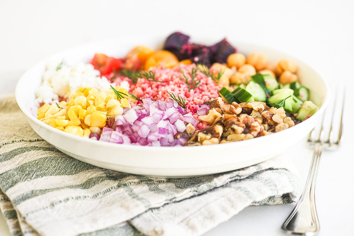 spring beet couscous salad in a shallow white bowl.