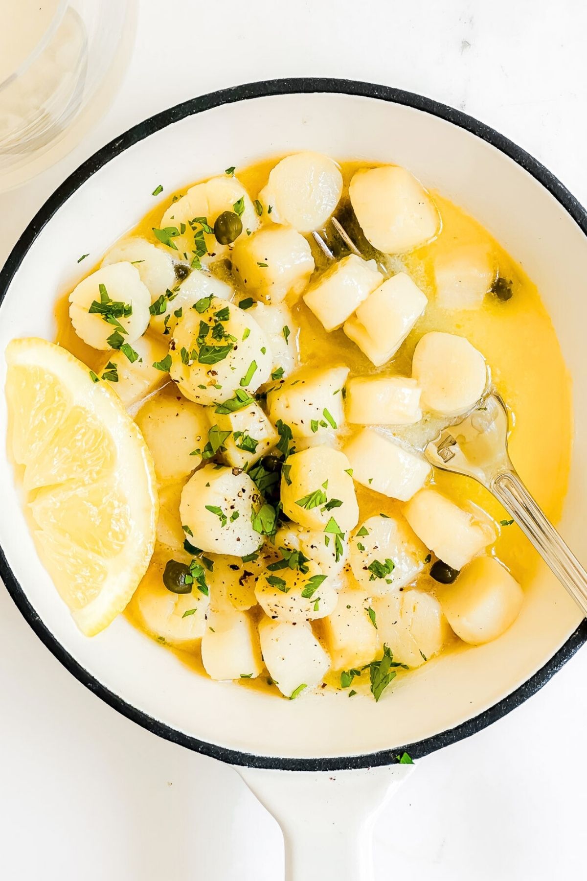 bay scallops in a saute pan.