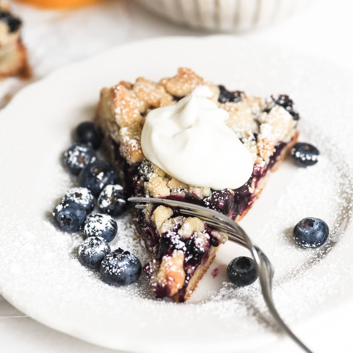 a slice of blueberry lemon crumble tart.