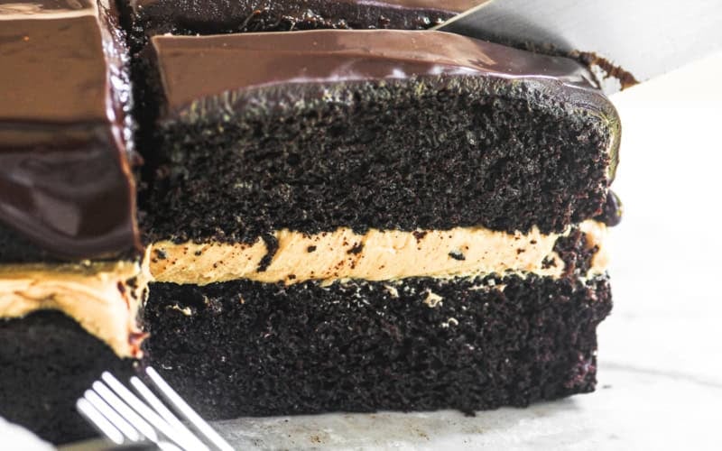slicing chocolate peanut butter cake.