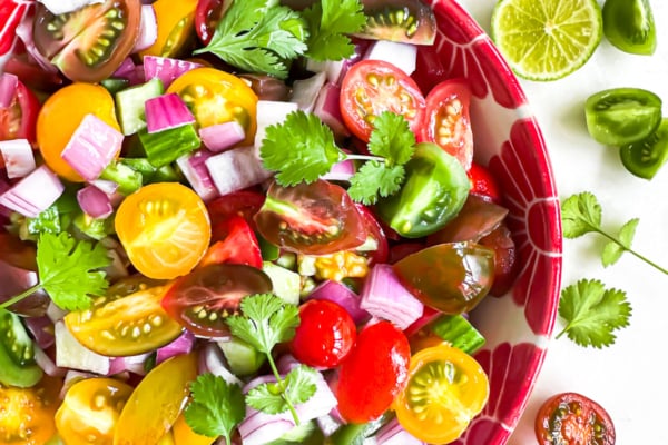pico de gallo salad in a bowl with spoon.