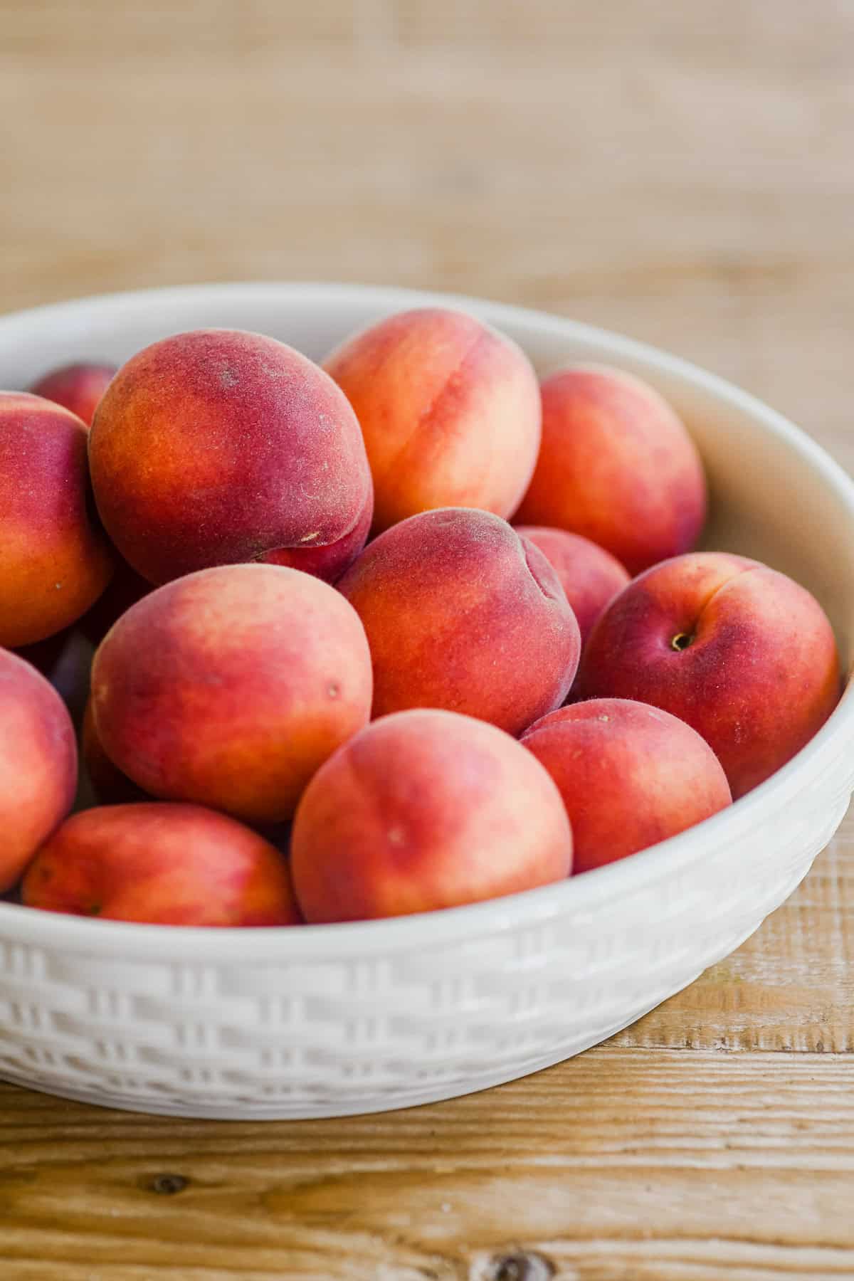 Apricots in a white bowl.