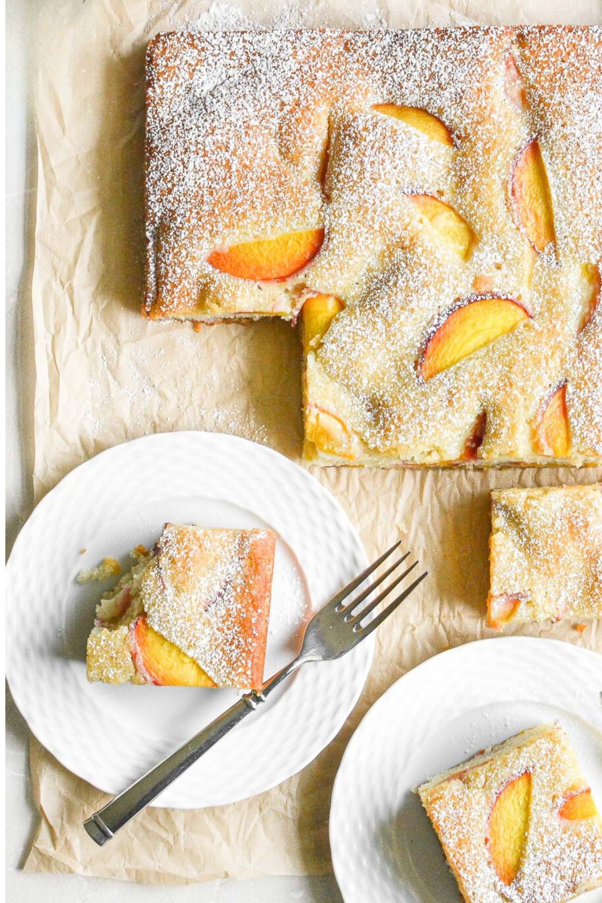 almond peach cake being served on white plates.