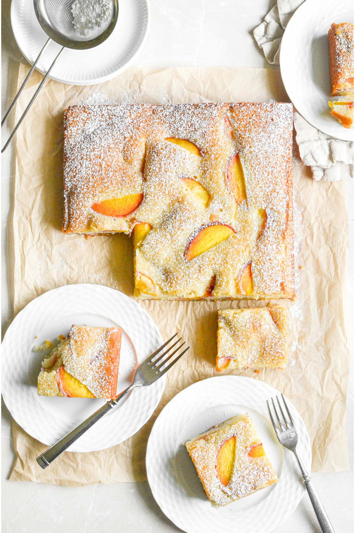 overhead look at almond peach cake on parchment paper.
