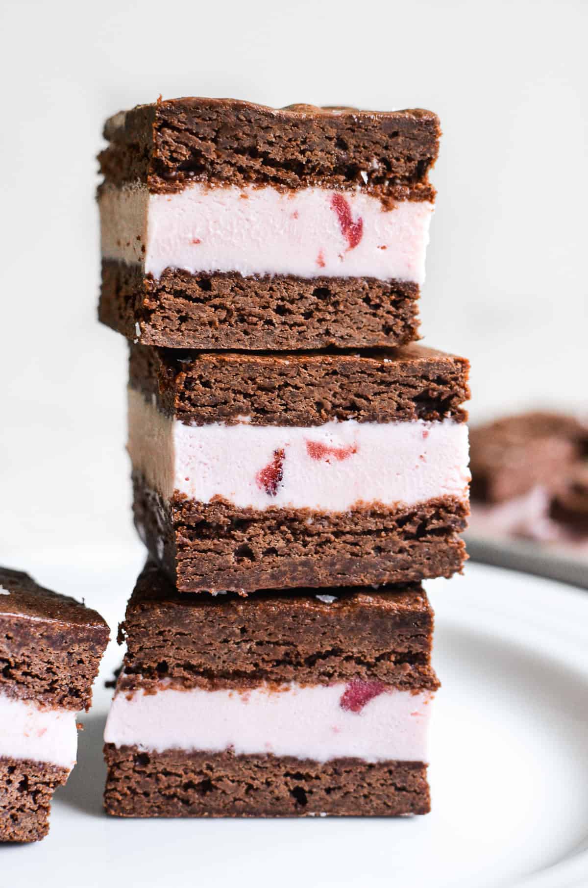 A stack of three strawberry ice cream sandwiches.