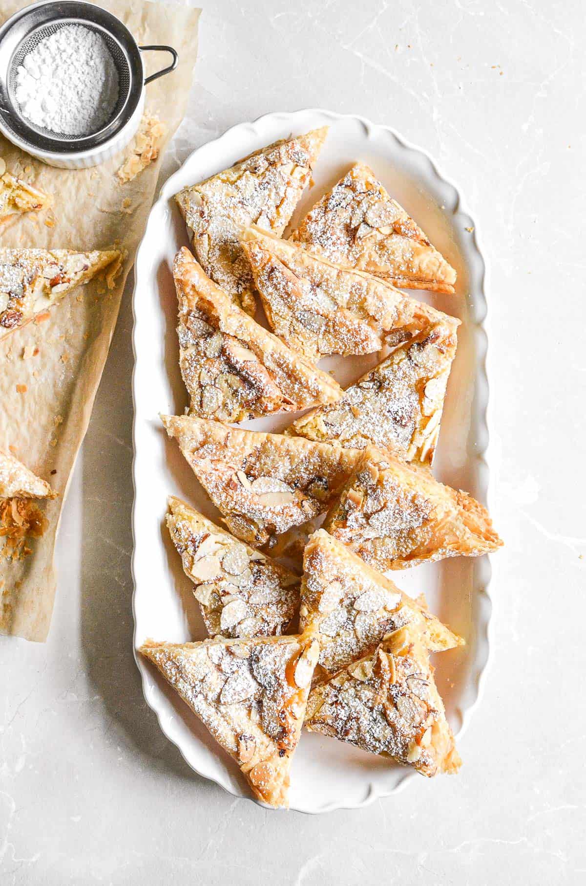 sheet pan almond croissants on an oval platter.