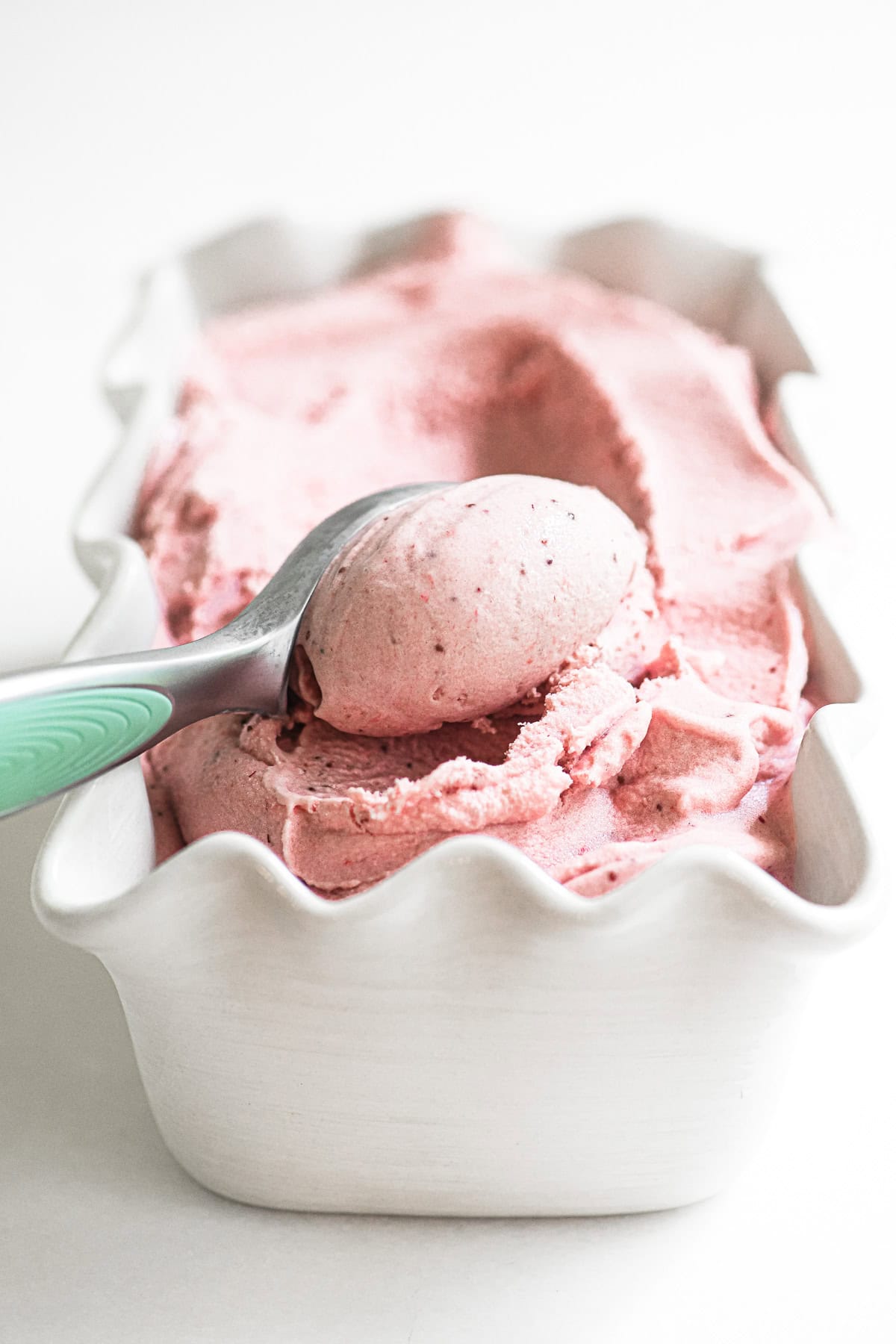 Scooping strawberry buttermilk ice cream.