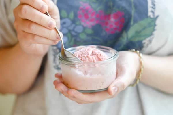 Strawberry buttermilk ice cream in a small glass.