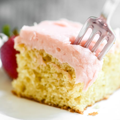 Taking a bite of strawberry sheet cake.