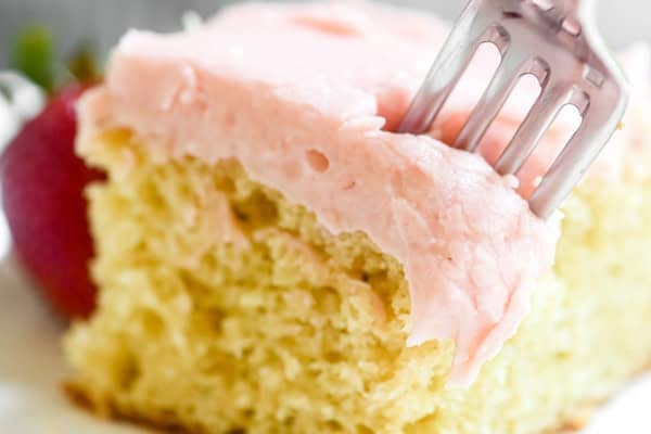 Taking a bite of strawberry sheet cake.