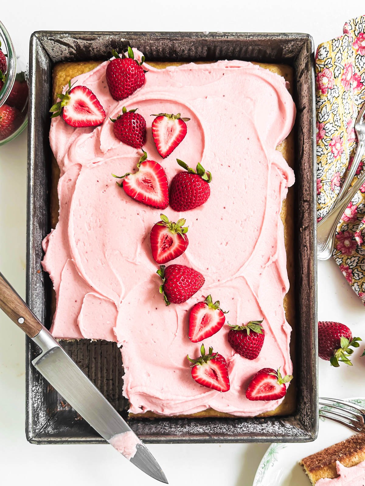 strawberry sheet cake topped with fresh berries.