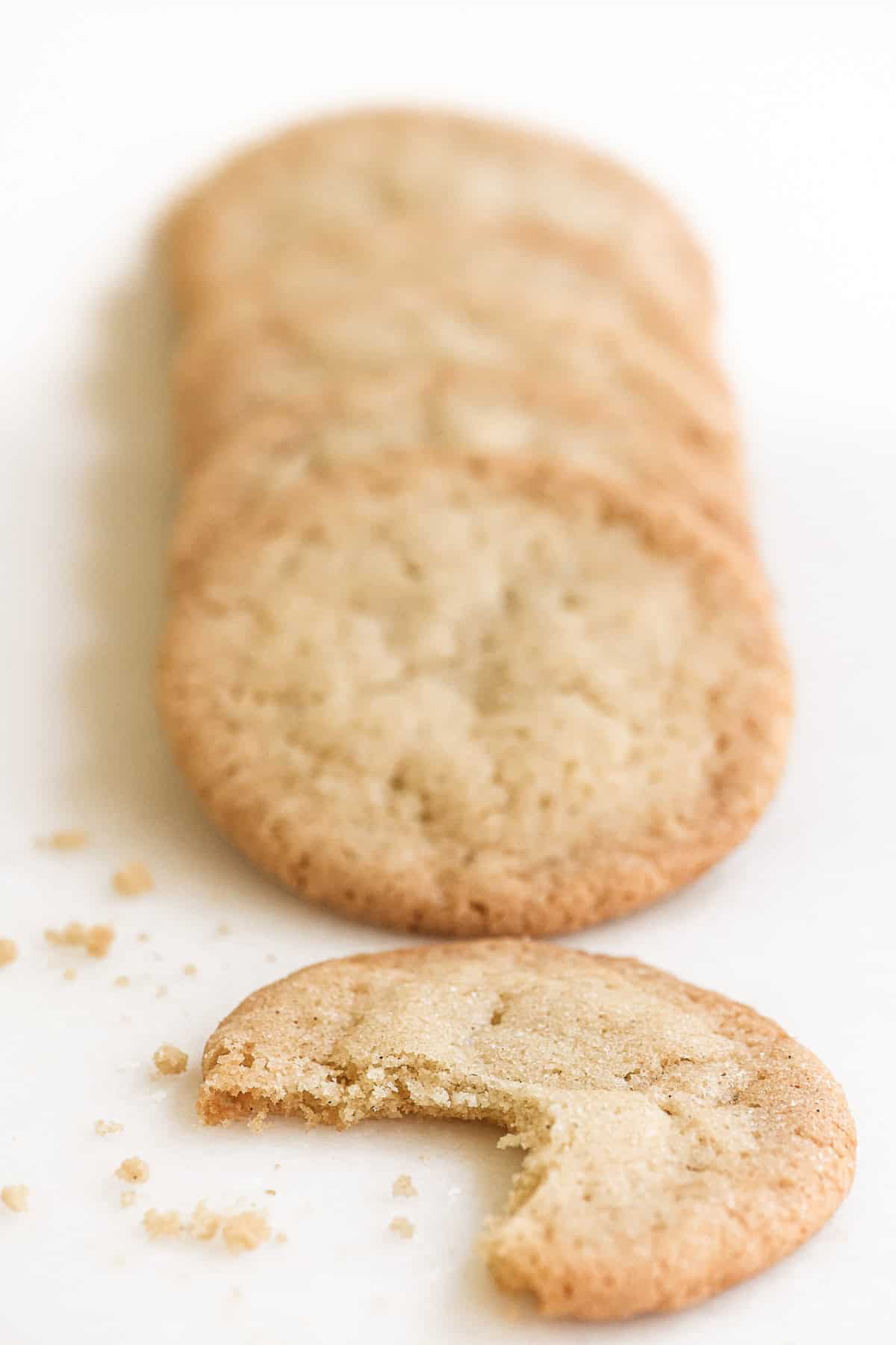thin and crispy sugar cookies with bite taken.