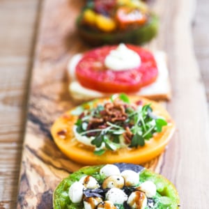 Colorful tomato flights on a long wooden platter.