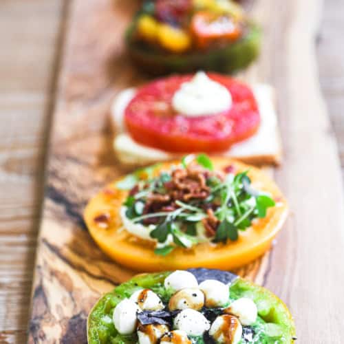 Colorful tomato flights on a long wooden platter.