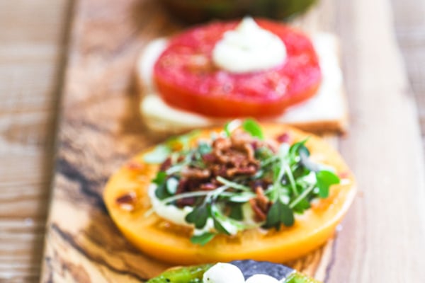 Colorful tomato flights on a long wooden platter.