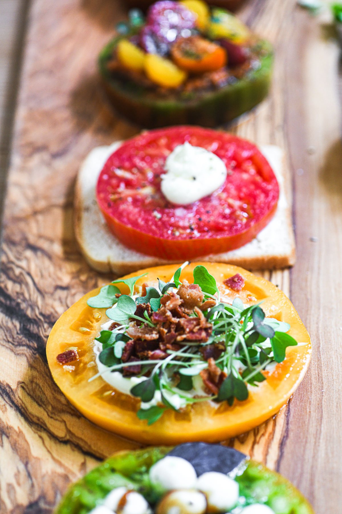 a tomato flight on an olive wood platter.