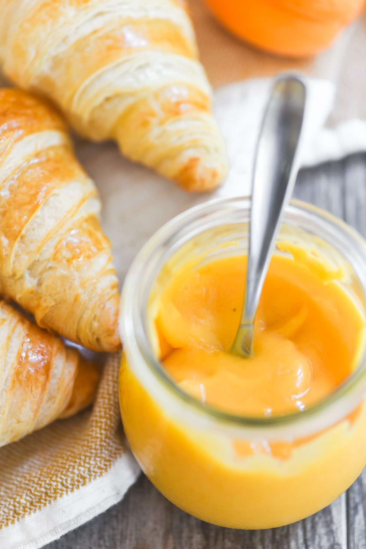 spoon plunged into a jar of thick apricot curd.